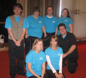 Group of ArtSteam actors smiling in teal t-shirts