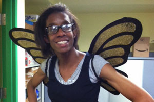 Smiling woman with costume butterfly wings