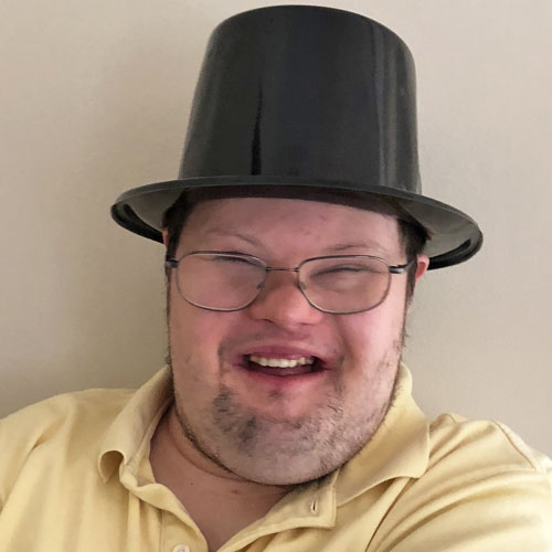 Smiling man in a top hat.