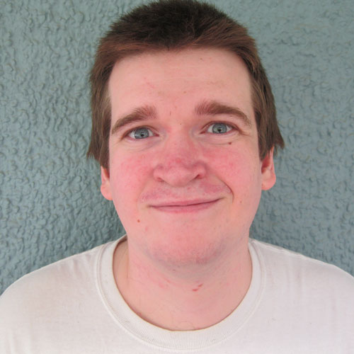Headshot of a smiling man.