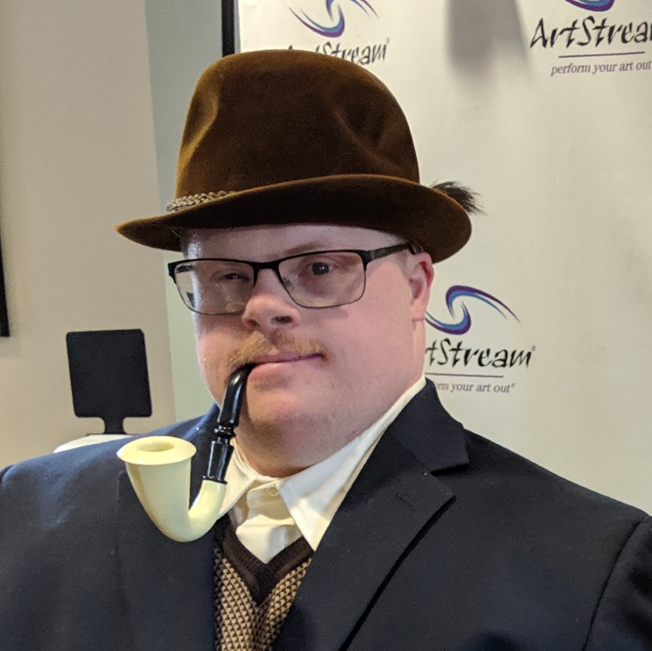 Headshot of Nick Kramp in a hat with a pipe