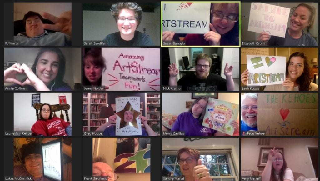 group of individuals on a zoom call holding signs that say we love artstream