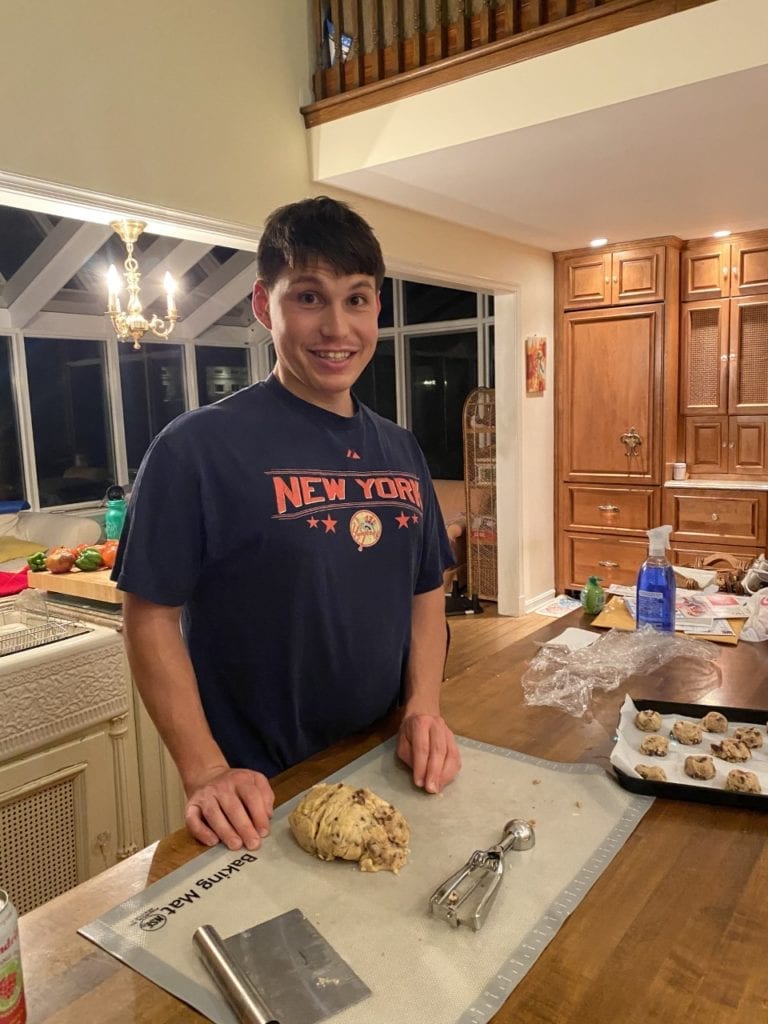 Elias Tsakiris smiling while cooking in his kitchen