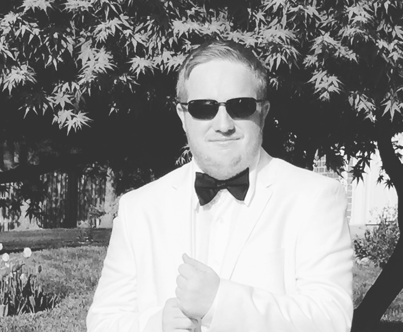 Headshot of Joey Kitchelt in a white tuxedo
