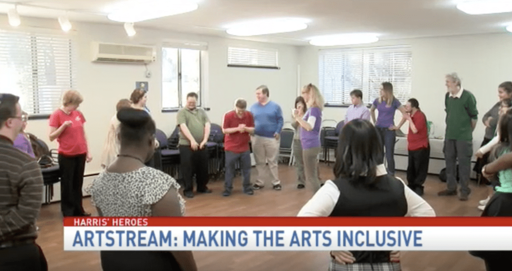 ArtStreamers stand in a circle with a banner at the bottom that reads "ArtStream: Making the Arts Inclusive"